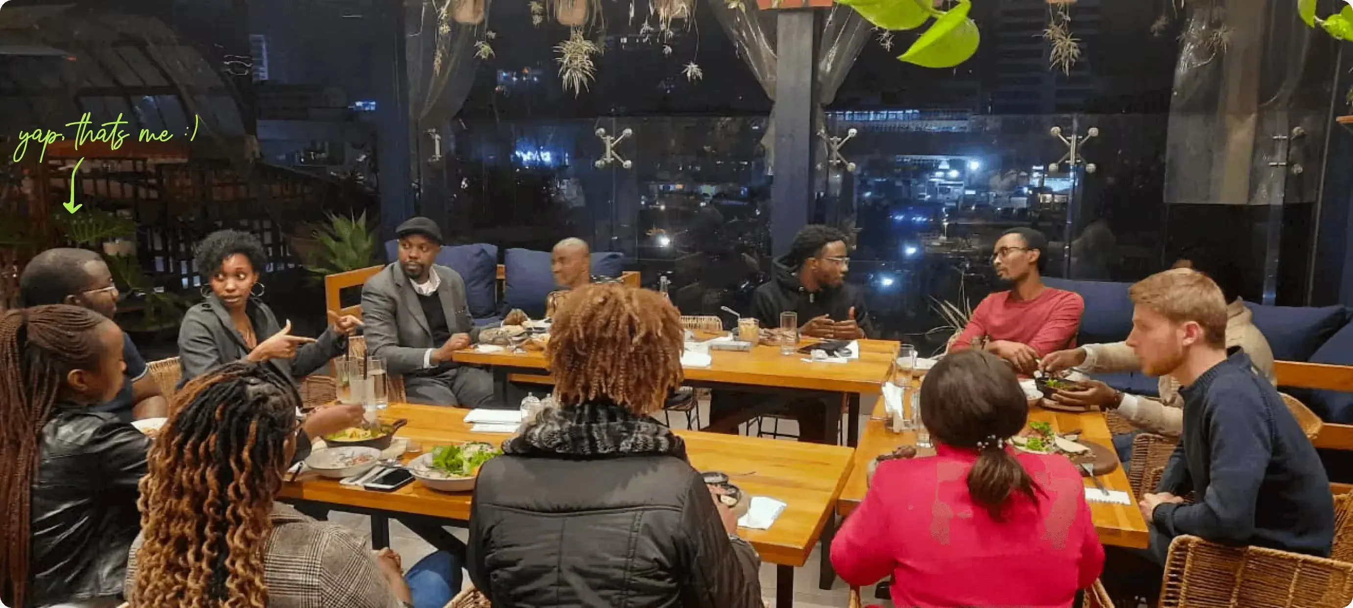 The Sendy team at a group dinner, with a handwritten arrow marking the designer.